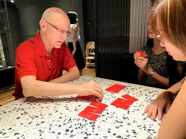 Bill Hajdu conducting a Mahjong Tarot reading with a client